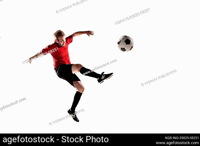 Athlete kicking soccer ball