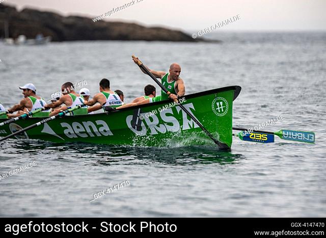 Crew of Hondarribia rowing boat in action during XV Bandera Fabrika men’s regatta of the ACT League (The Association of Clubs of rowing boats) in La Concha Bay