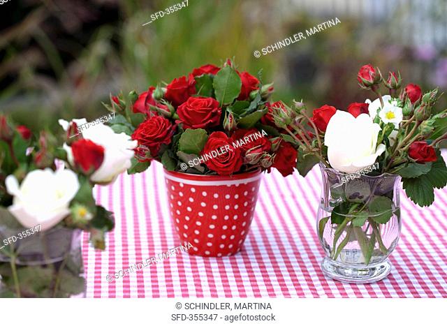 Different bunches of roses on a garden table