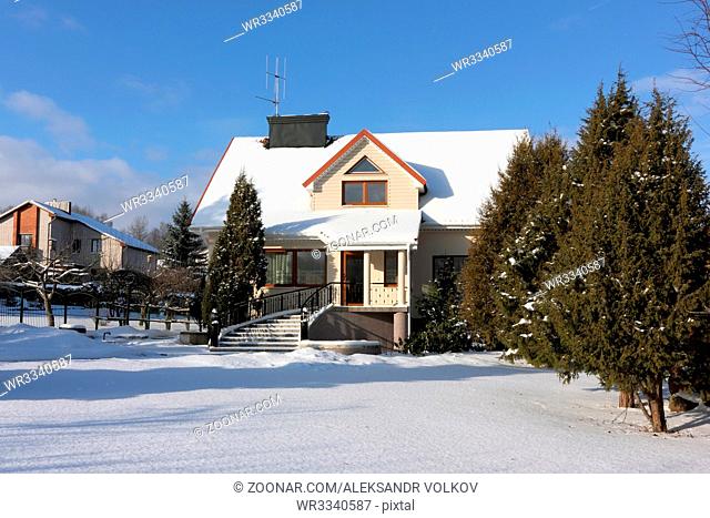 VILNIUS, LITHUANIA - JANUARY 17, 2016: The uninhabited elite house and garden in the village of Buividiskes are brought by cold snow