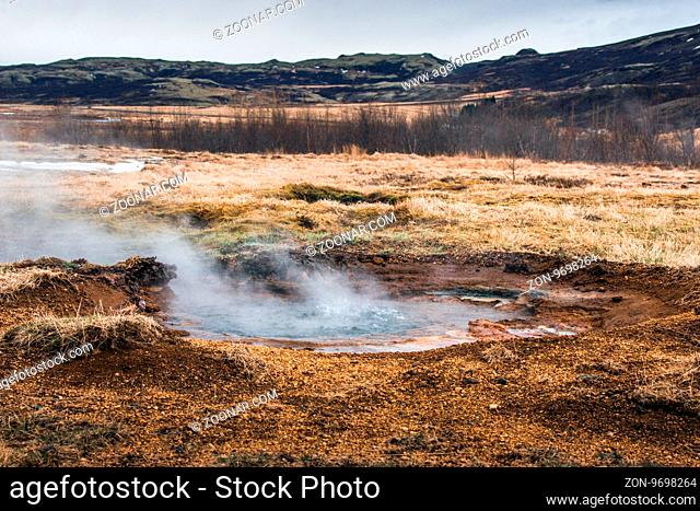 Boiling water in a puddle in icelandic nature