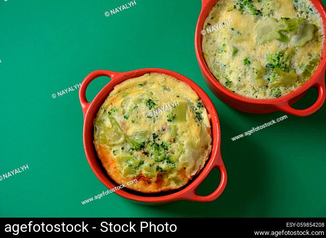Healthy snack Broccoli with eggs cheddar cheese and thyme close-up in mini casserole