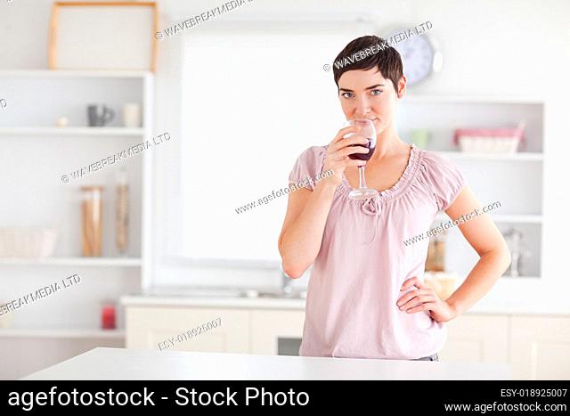 Joyful woman drinking wine