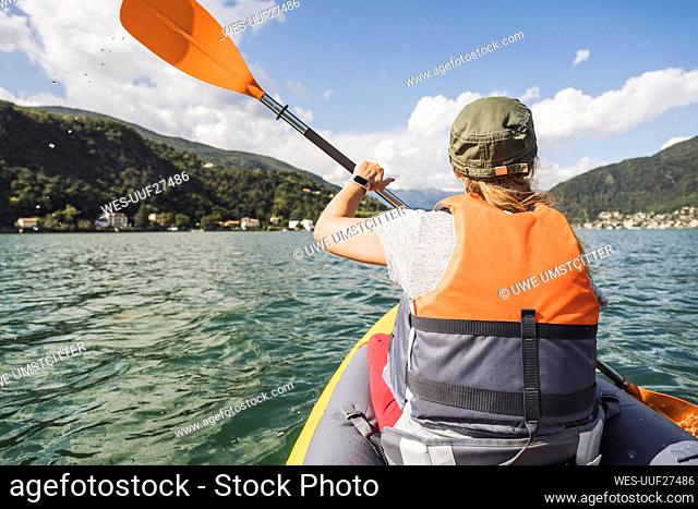 Mature woman kayaking on lake