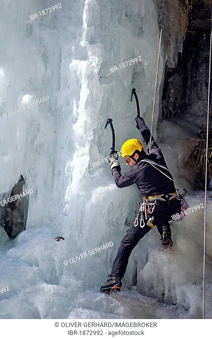 Ice climber climbing a frozen waterfall in the Malta Valley, Hohe Tauern National Park, Alps, Carinthia, Austria, Europe