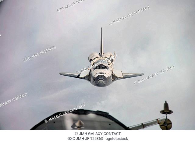 Space shuttle Discovery is featured in this image photographed by an Expedition 26 crew member as the shuttle approaches the International Space Station during...