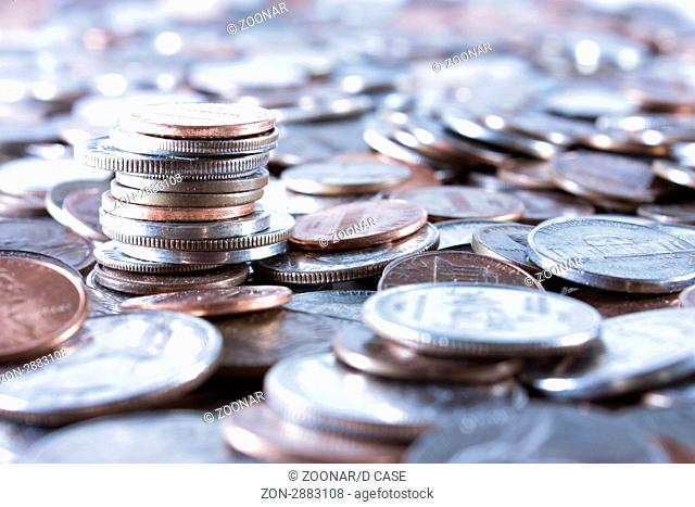 Stack of coins in a sea of coins