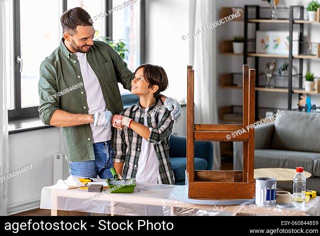 father and son making fist bump and restore table
