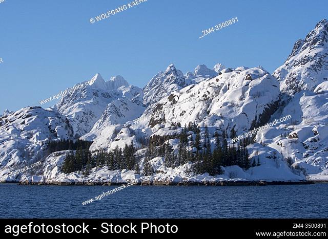 View of snow covered mountains on Austvag Island near the famous Trollfjord in the Lofoten Islands, Nordland County, Norway