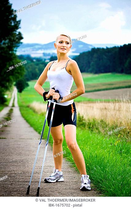 Young woman doing Nordic walking