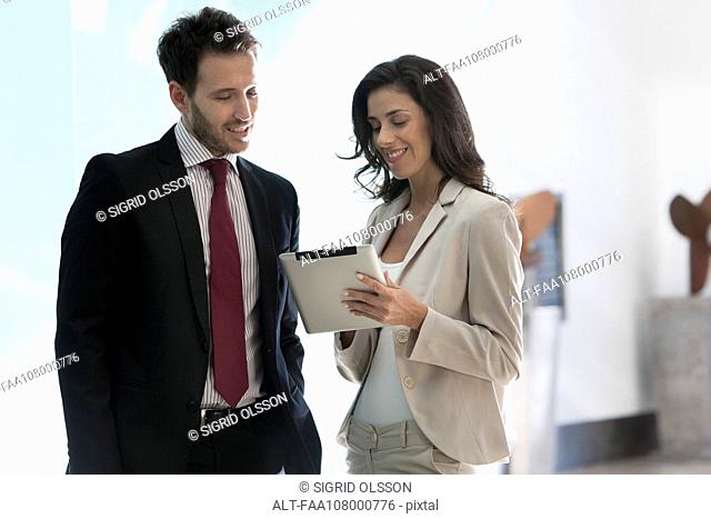 Business associates working together using digital tablet