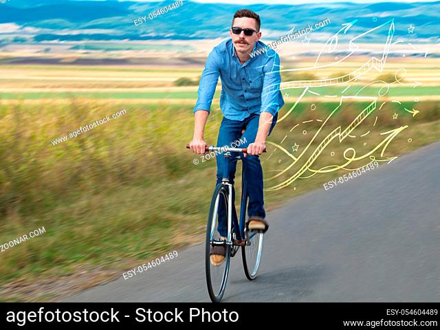 Young cyclist in casual clothing with fabulous nature background