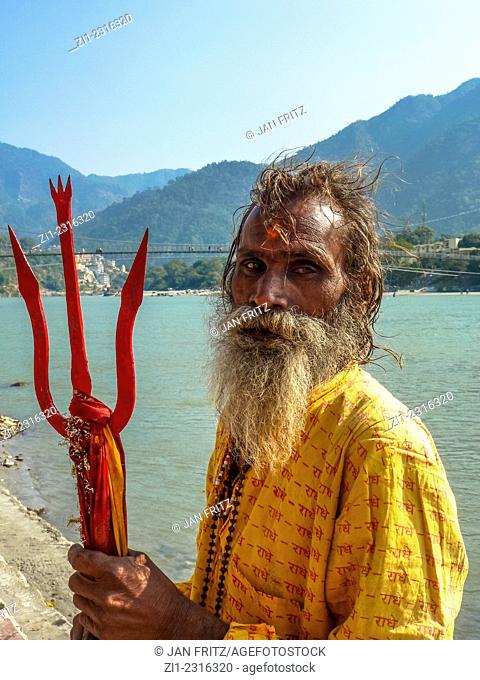 portrait of sadhu with beard and trident in rishikesh, india