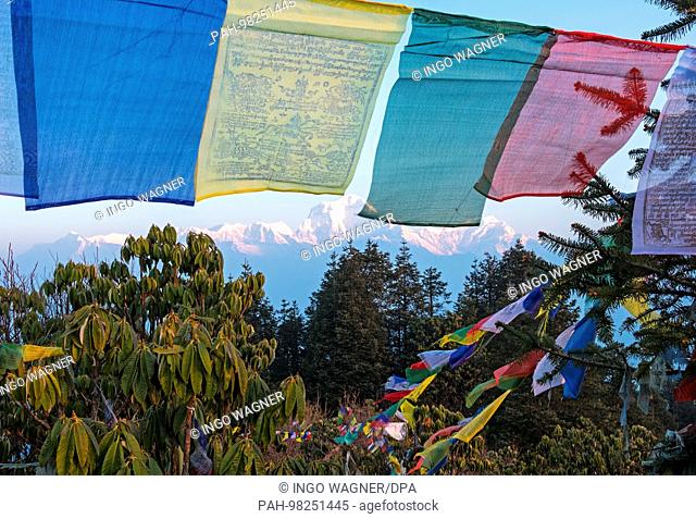 Prayer flags flutter on 12.04.2017 at sunrise before the Annapurna Range mountain panorama in Poon Hill near Ghorepani / Nepal in the Annapurna Conservation...