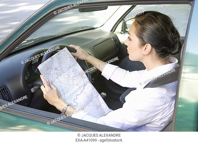 Businesswoman looking at map in car