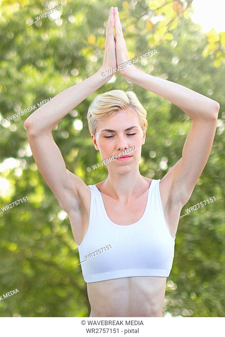Woman doing yoga Meditating by trees