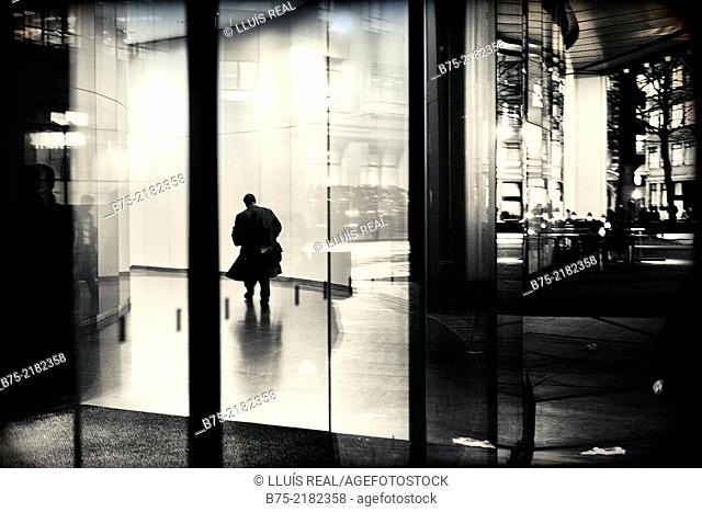 unrecognizable businessman walking down the hall of an office building in the city of London, England, UK