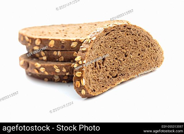 Sliced whole grain bread with oat flakes. Wholemeal bread isolated on white background