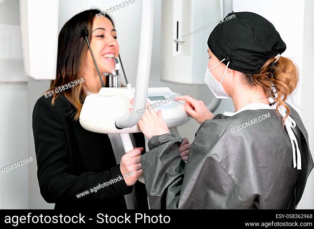 Young woman patient standing in x-ray machine. High quality photo