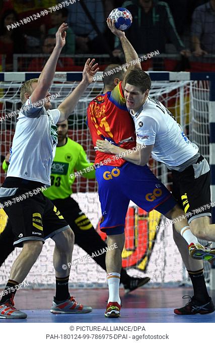 Germany's Patrick Wiencek (L) and Finn Lemke (R) try to prevent Spain's Joan Canellas from throwing the ball during the European Men's Handball Championship...