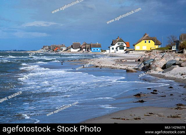 Colorful houses on the beach of Graswarder, Heiligenhafen