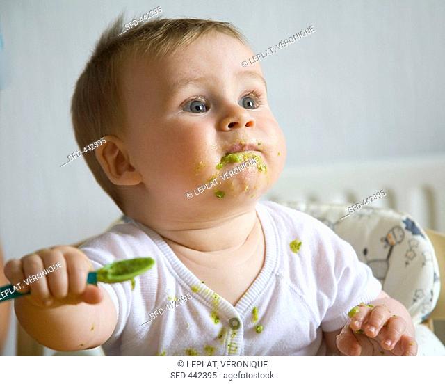 Baby eating pureed vegetables