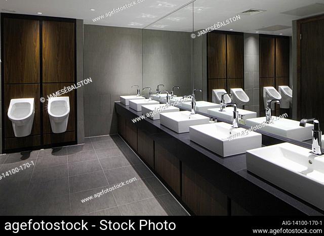 Gents WC with row of hand basins and urinals against wood panels | Architect: PHP Architects |