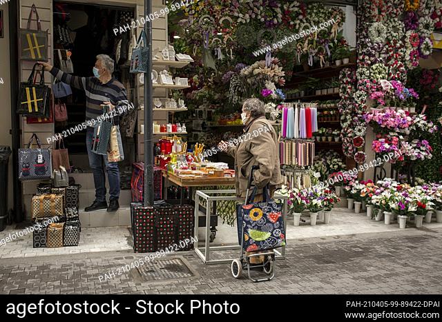 05 April 2021, Greece, Athen: A woman shops in a downtown store. From Monday, 05.04.2021, shops in large parts of Greece will be allowed to reopen after weeks...