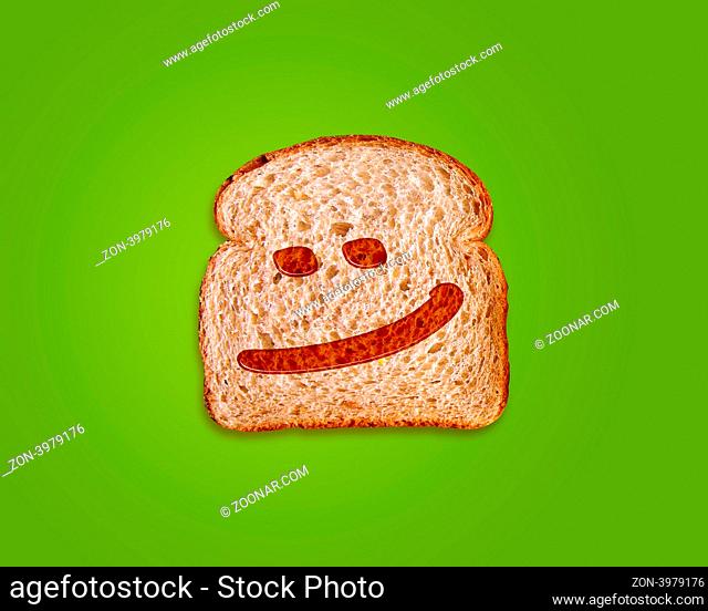 toasted bread slice with smile sign on green made by honey background