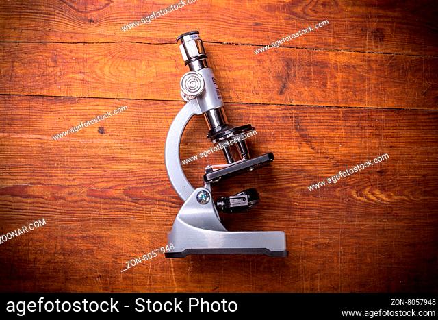 Microscope on table for vintage science background