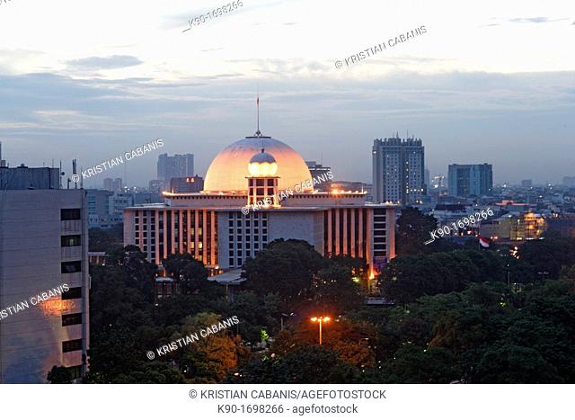 Istiqlal mosque of Jakarta at dawn with city lights, Indonesia, Southeast Asia