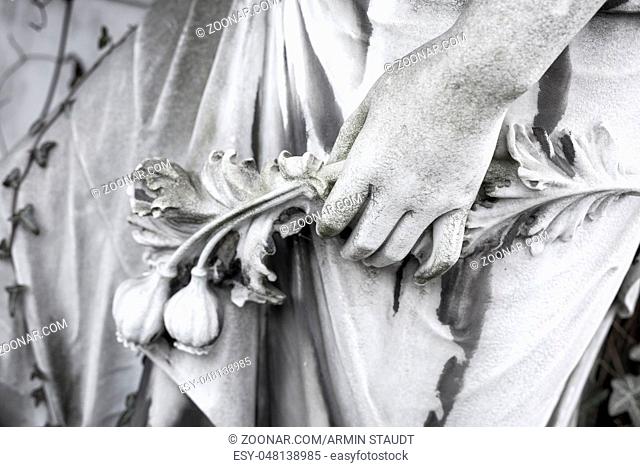 hand with flowers, close up of an old sculpture. Unknown artist of the 19th century