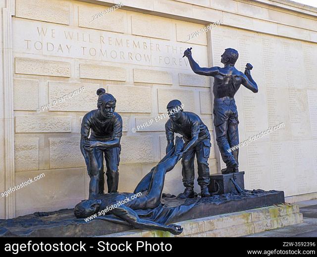 The Armed Forces Memorial at National Memorial Arboretum near Lichfield , Staffordshire . Sculpture of the body of a warrior is being prepared for burial by...