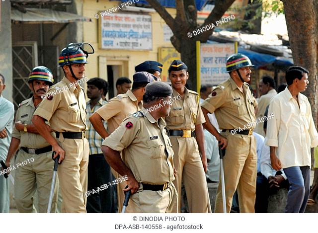 Police personnel patrolling when rioters break glass panes of vehicles in Bhandup after the Dalit community resort to violent protests ; Bombay now Mumbai ;...