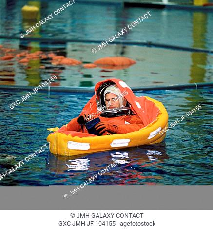 Astronaut Paul S. Lockhart, STS-111 pilot, floats in a small life raft during an emergency bailout training session in the Neutral Buoyancy Laboratory (NBL)...