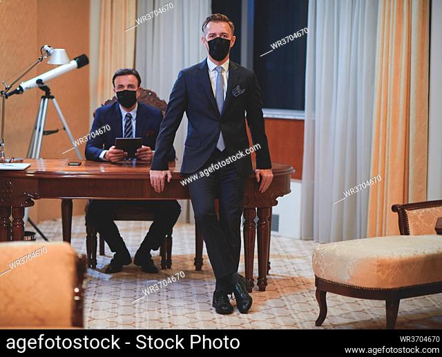corporate business team wearing crona virus protection face mask keep social distance in luxury office