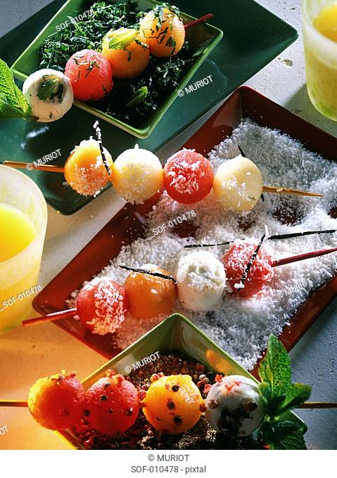 Little brochettes with melon, watermelon and three cheese balls