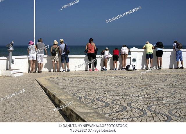 Europe, Portugal, Algarve, Lagos, tourists watching Atlantic Ocean
