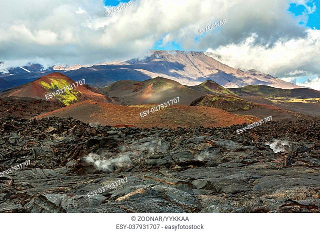 Lava field at Tolbachik volcano, after eruption in 2012 on background Plosky Tolbachik volcano, Klyuchevskaya Group of Volcanoes