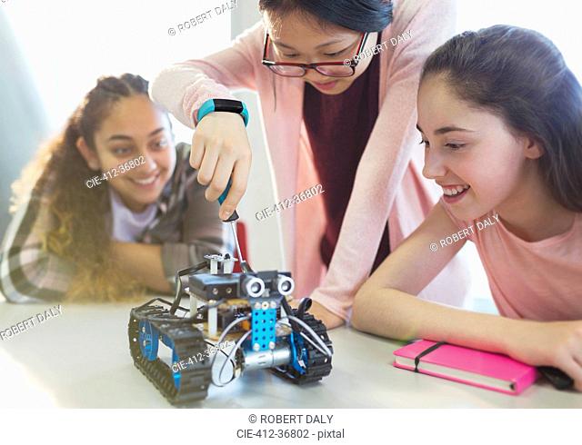 Girl students assembling robotics in classroom
