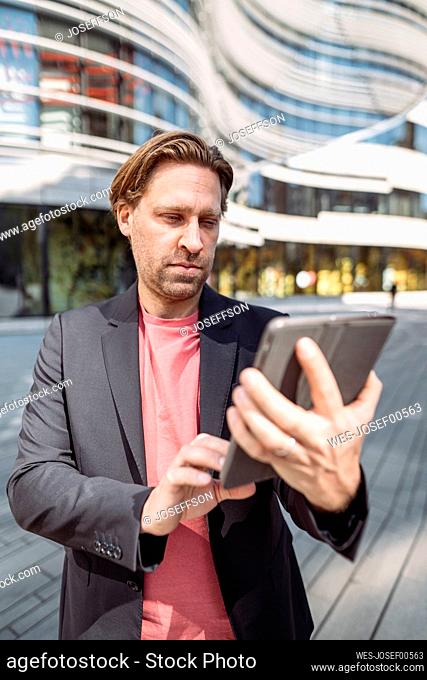 Businessman using tablet in the city