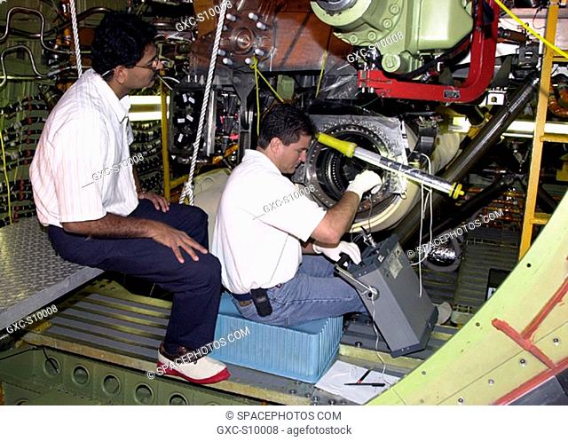 07/01/2002 -- After engine removal on Columbia, the flow line is being inspected by left A.J. Koshti, with The Boeing Co
