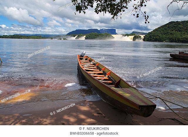 dugout in a lagoon, Canaima waterfalls in background, Venezuela, Canaima National Park