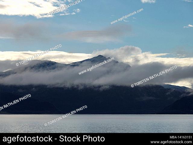 clouds in front of a mountain range on the north sea, nordland, norway