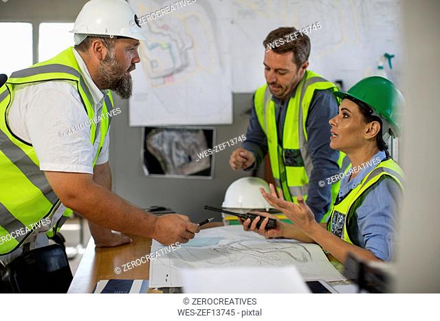 Workers discussing at site office