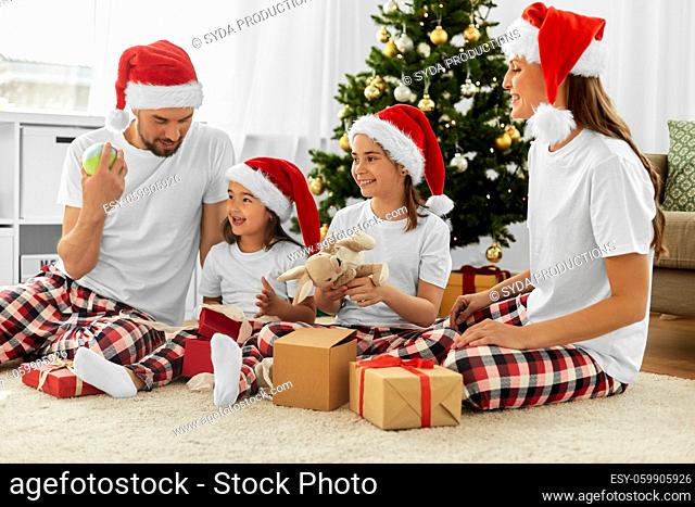 happy family opening christmas gifts at home