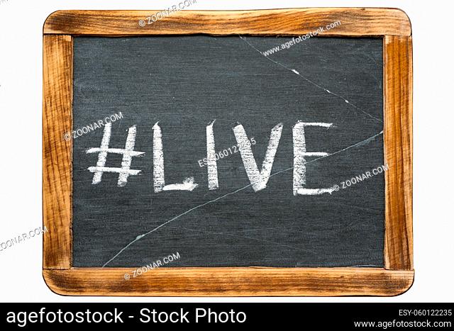 live hashtag handwritten on vintage school slate board isolated on white