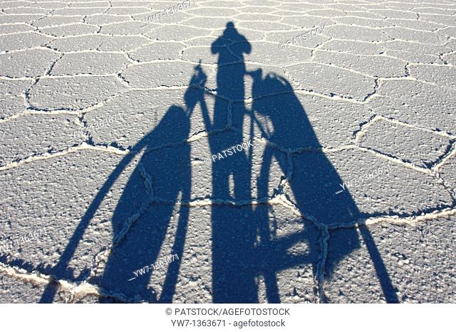 Shadow of a biker on the frozen salt lake called 'Salar de Uyuni' in Bolivia