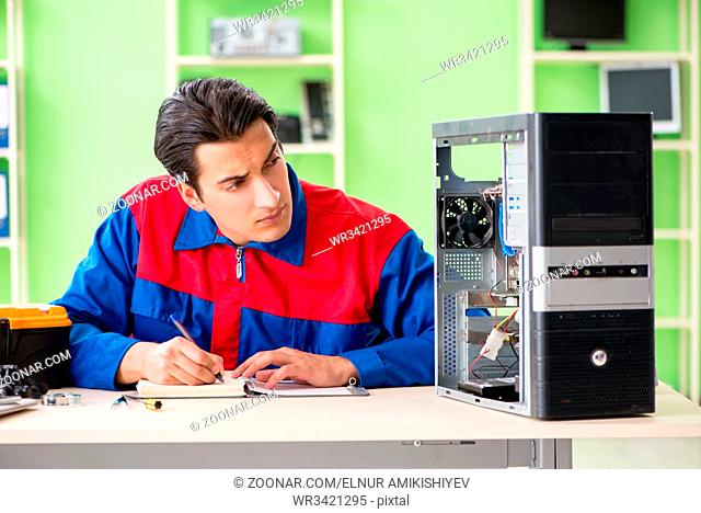 Computer engineer repairing broken desktop