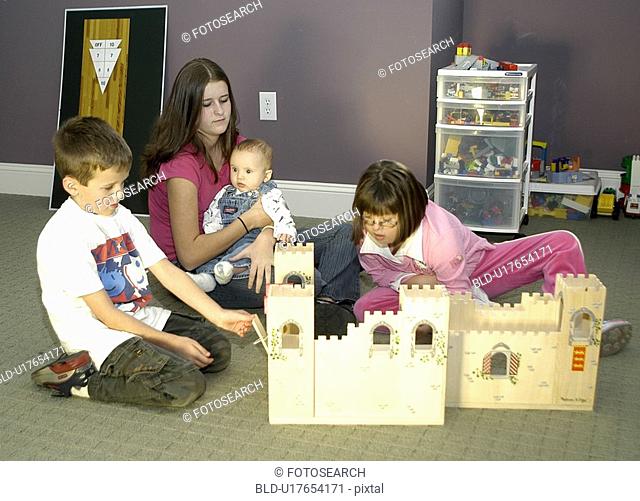 Children, including a child with Down Syndrome, playing with a castle